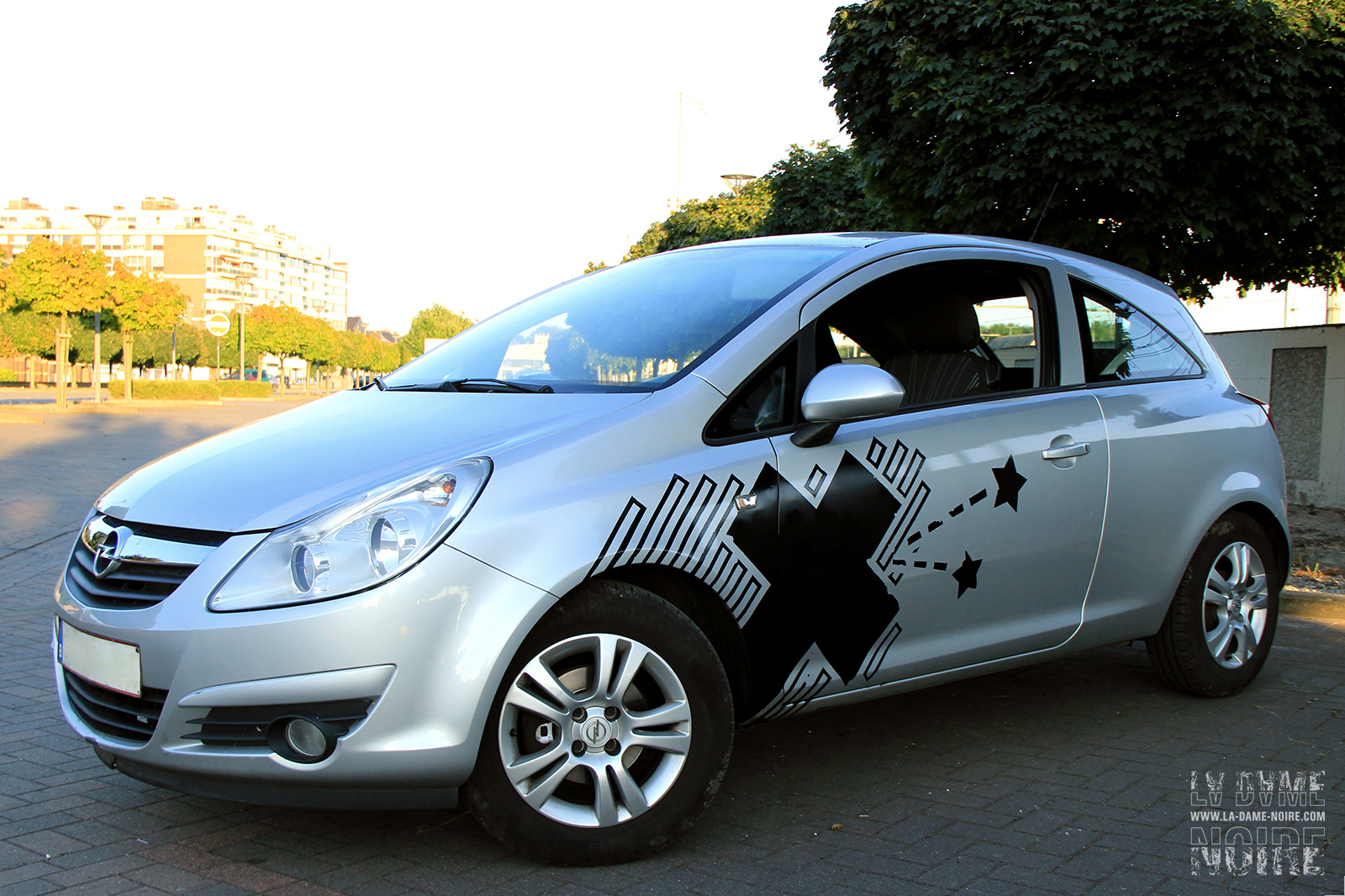 Left side of the Opel Corsa painted in black with a cross and some stars