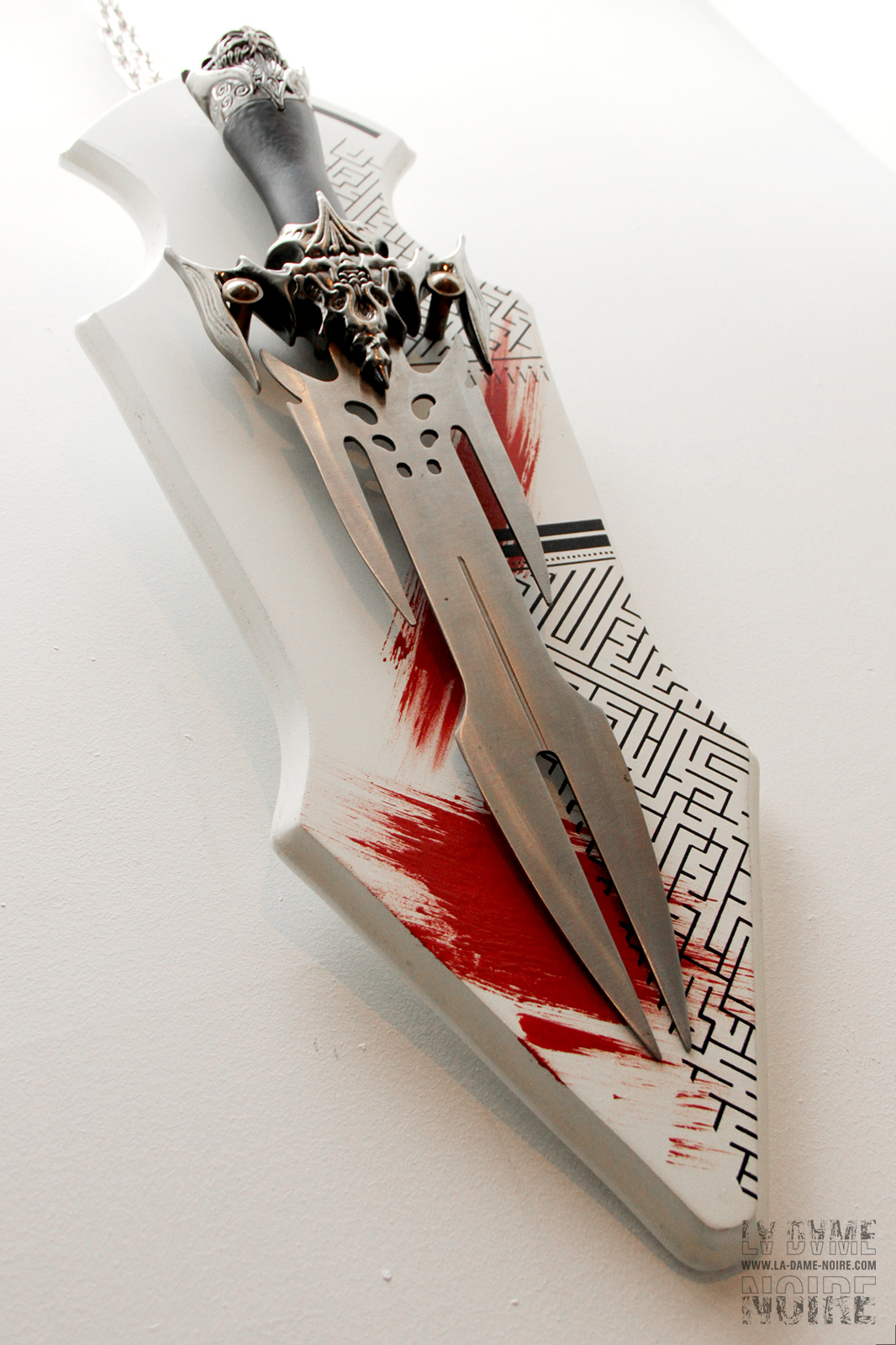 Details of a fantasy viking sword painted in white and red