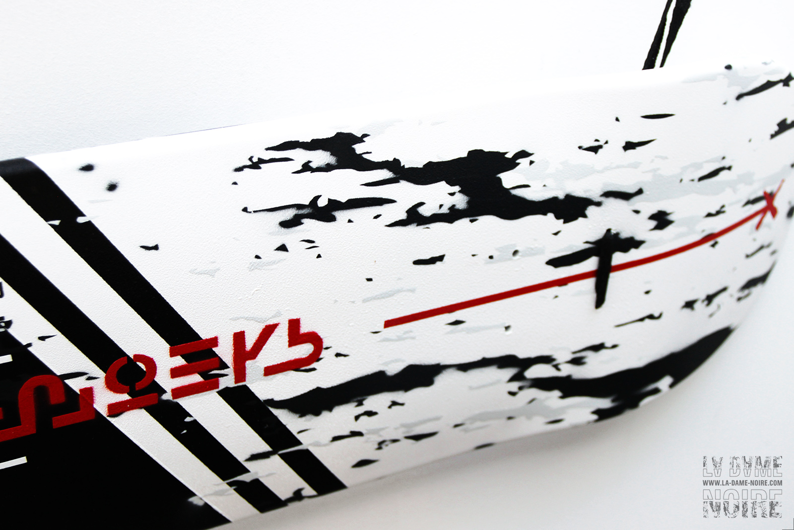 Details of the skateboard with red letters on white paint